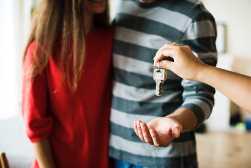 Couple being handed the keys to their new home